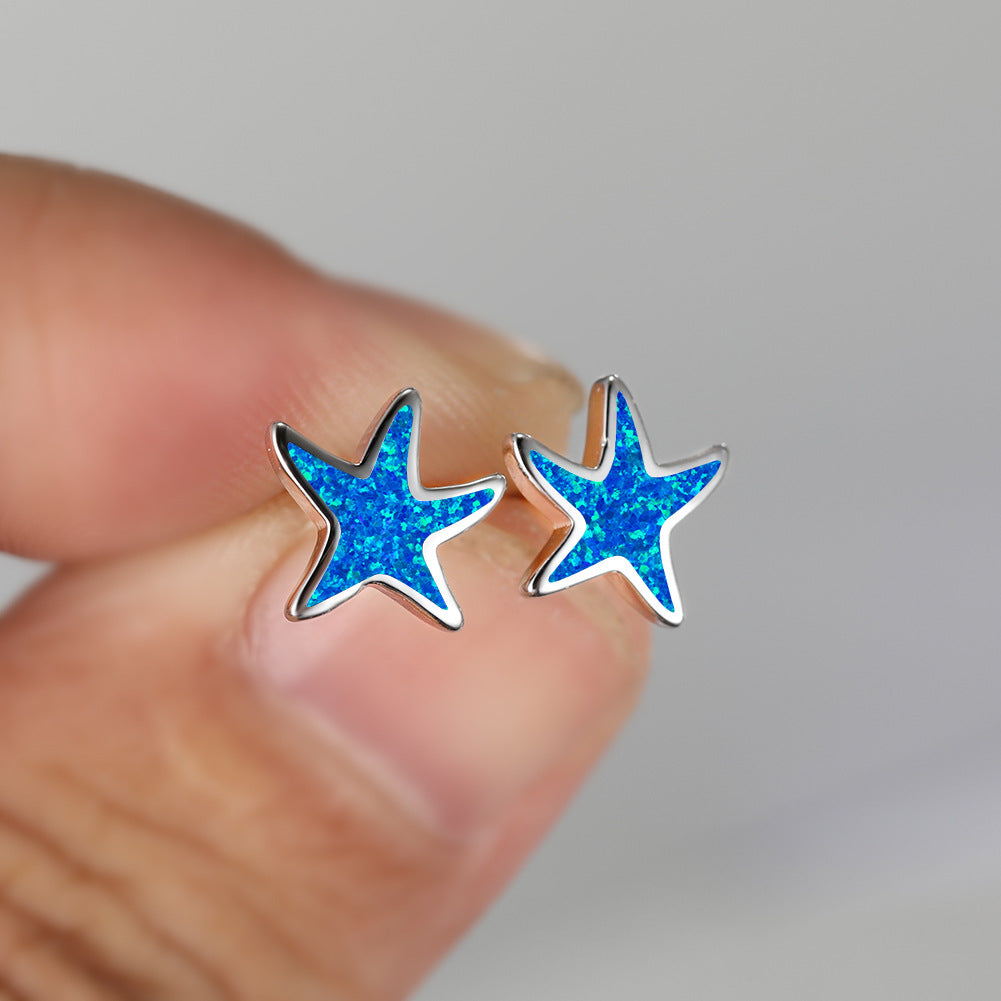 Sparkling blue opal starfish earrings for women, a beautiful sea theme accessory.