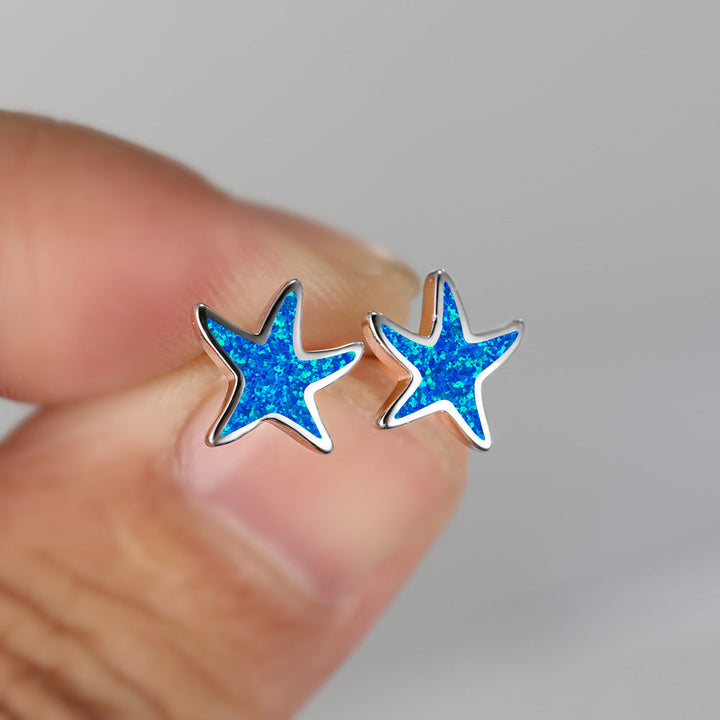 Sparkling blue opal starfish earrings for women, a beautiful sea theme accessory.