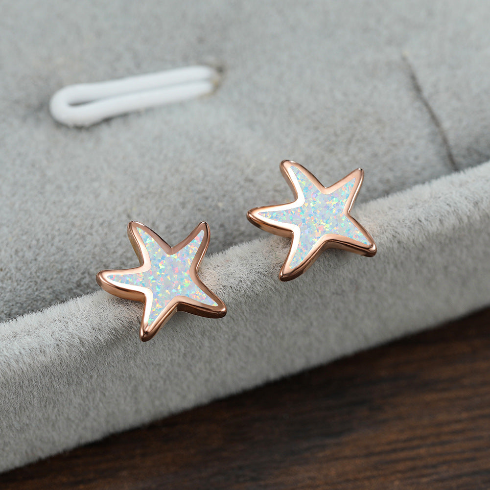 Dainty blue opal starfish earrings, women's jewelry, embodying the sea's beauty.