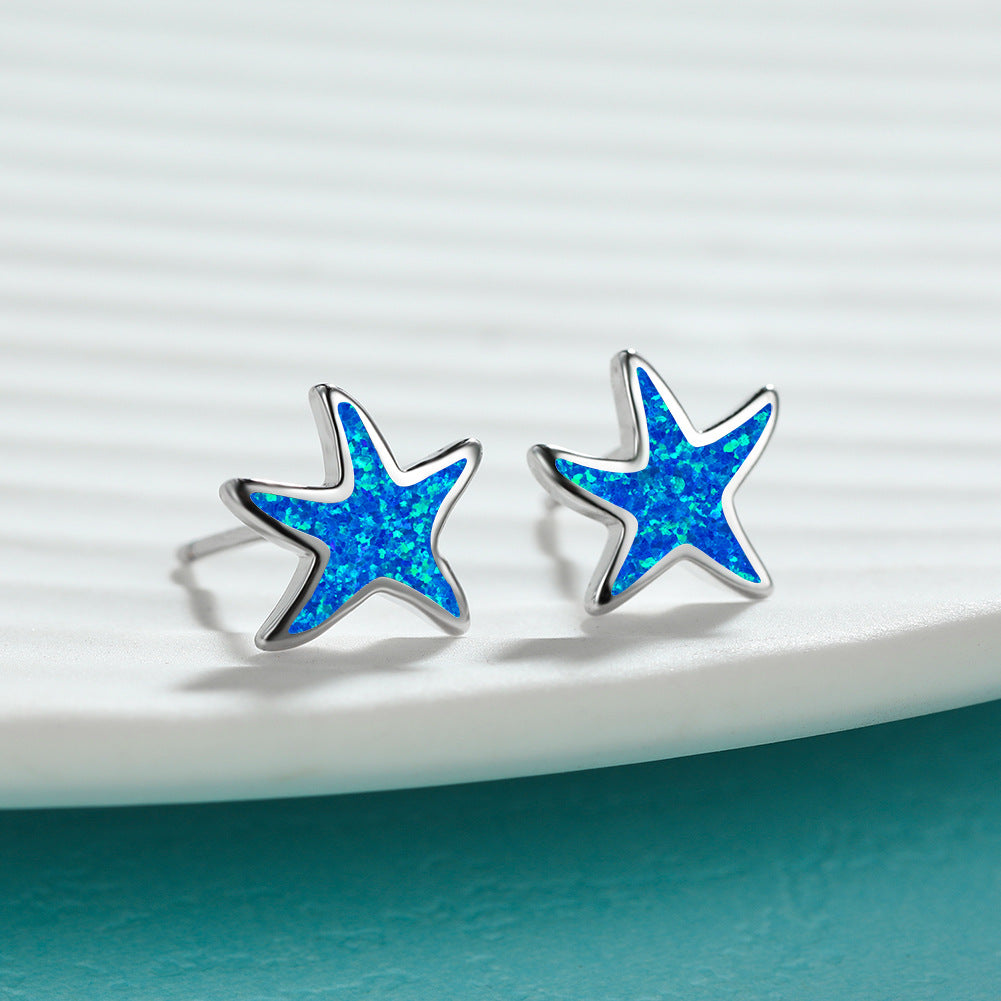 Dainty blue opal starfish dangle earrings, perfect ocean-inspired gift for her.