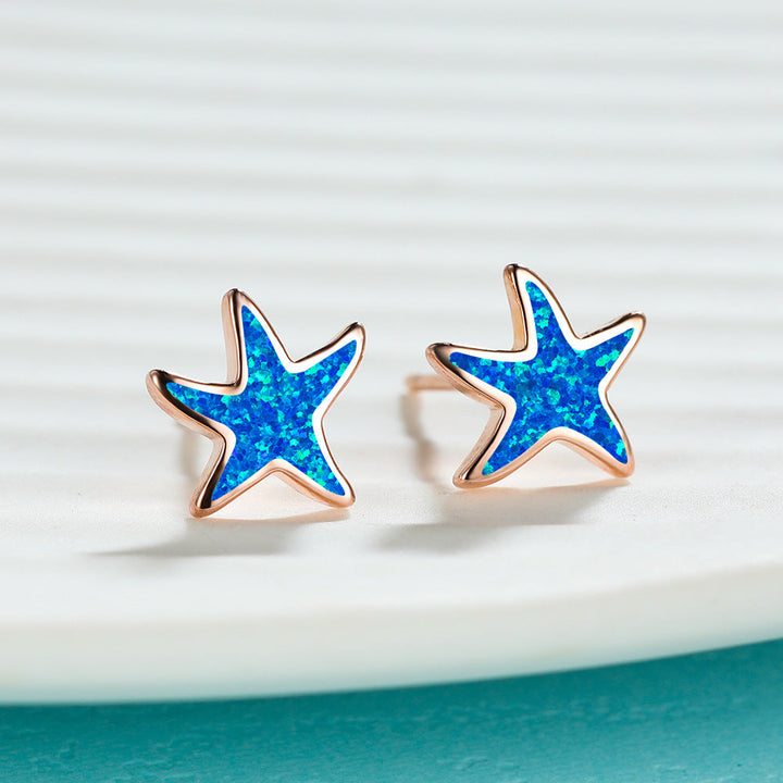 Women's sterling silver blue opal starfish earrings, unique sea-inspired accessory.