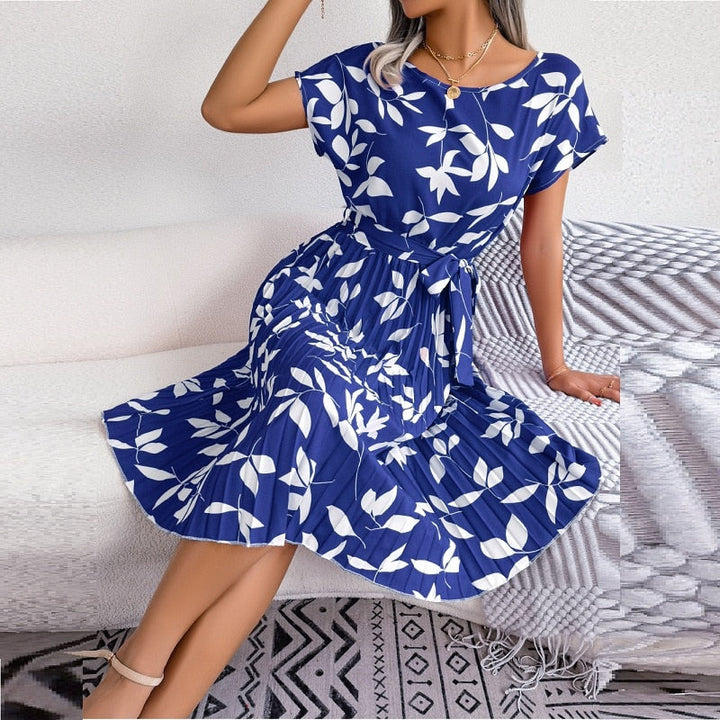 Close-up of women's blue printed midi dress, showcasing vibrant pattern and soft fabric for summer comfort.