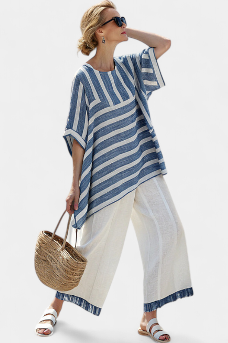 Fashionable women's blue striped two-piece set, ideal for summer, with a stylish batwing top & wide leg pants.