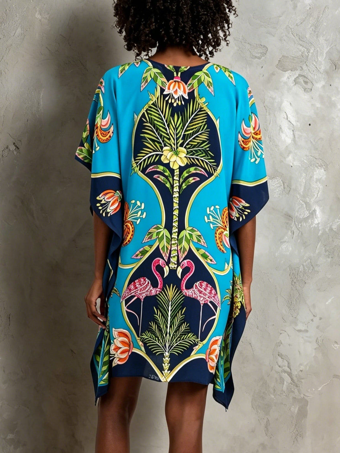 Flowy blue tropical V-neck kaftan midi dress for women. Ideal casual elegance, summer fashion, and bohemian style.