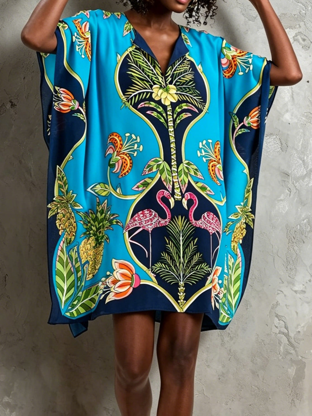 Elegant blue tropical midi dress with batwing sleeves and V-neck. A stylish choice for women's resort and summer wear.