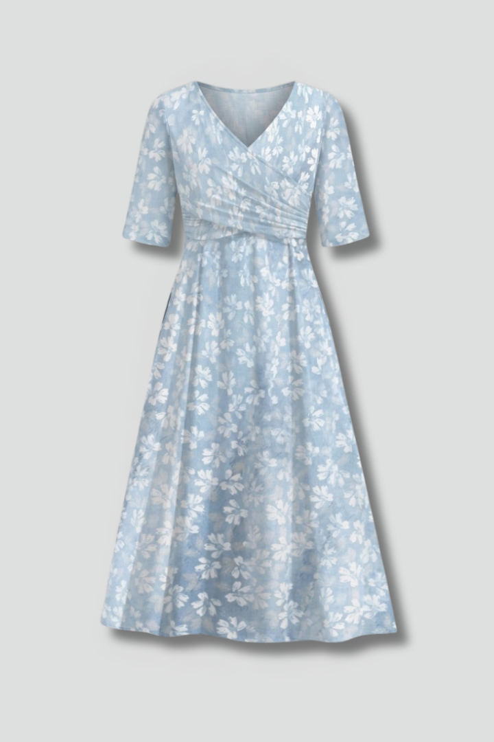 Women's blue V-neck midi dress with short sleeves & practical pockets. Comfortable & stylish for effortless everyday wear.