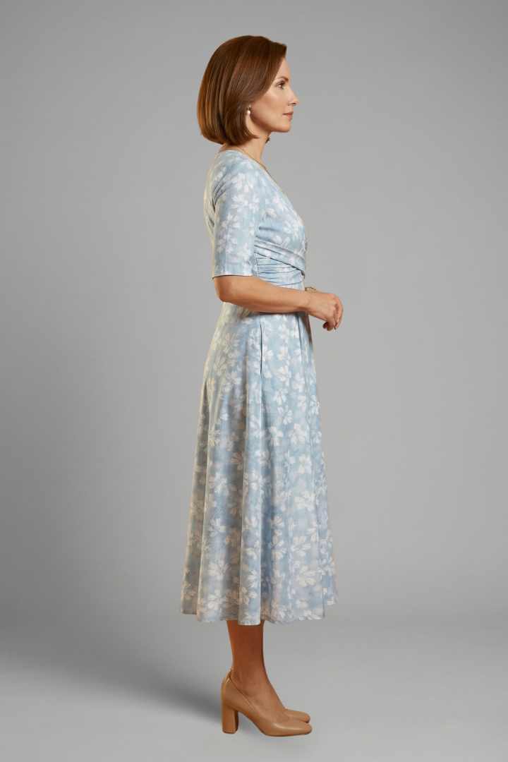 Stylish women's V-neck midi dress featuring short sleeves & convenient side pockets. Effortless feminine fashion.