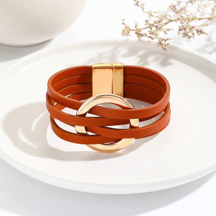 Women's adjustable Bohemian double circle leather bracelet worn on a wrist, a trendy fashion accessory.