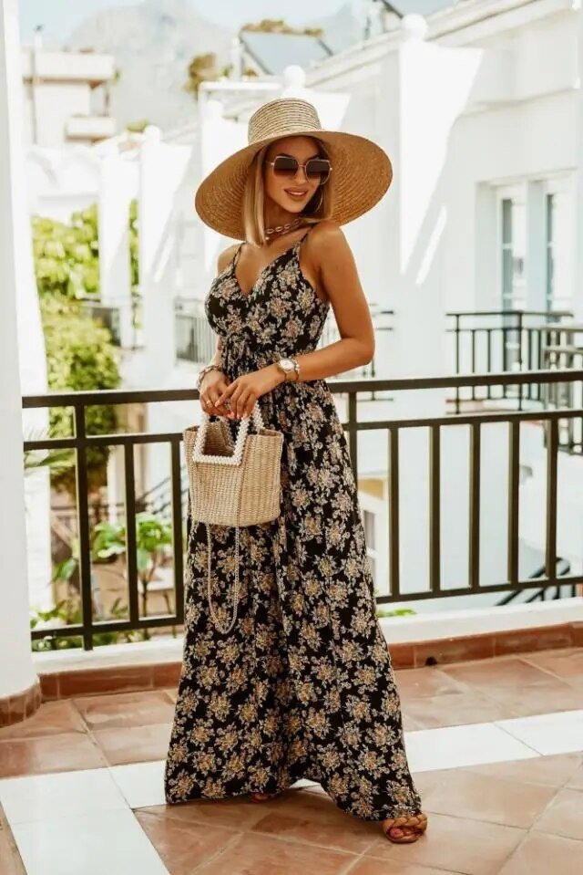 Back view of women's boho floral maxi dress, showing flowy skirt and elegant drape