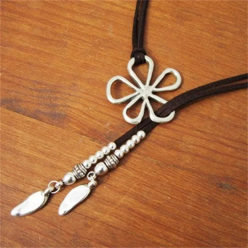 Women's ethnic style necklace with bohemian floral pendant. Stainless steel trendy accessory.