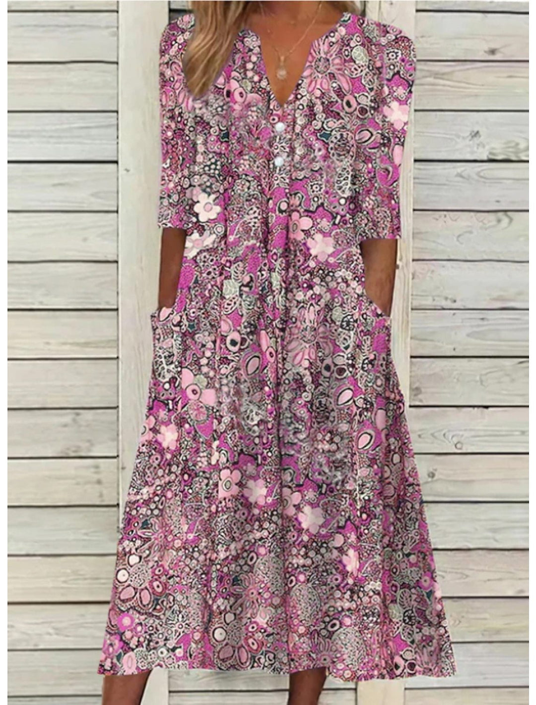 Flowy Bohemian floral print midi dress for women. Relaxed fit, v-neck, half sleeve. Stylish spring/summer casual.