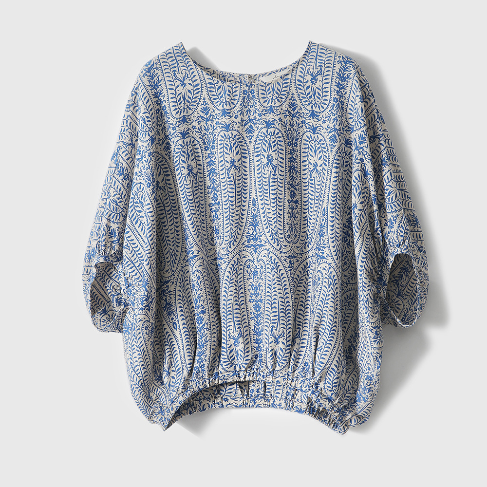 Orange and blue bohemian floral print women's blouse. Relaxed fit pullover with long sleeves for spring fashion.