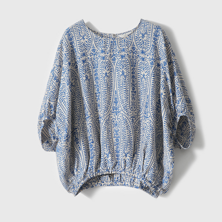 Orange and blue bohemian floral print women's blouse. Relaxed fit pullover with long sleeves for spring fashion.