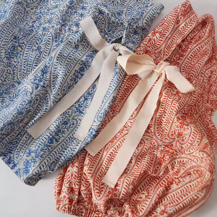 Casual women's boho long-sleeve floral pullover top. Vibrant orange & blue printed blouse, relaxed fit.