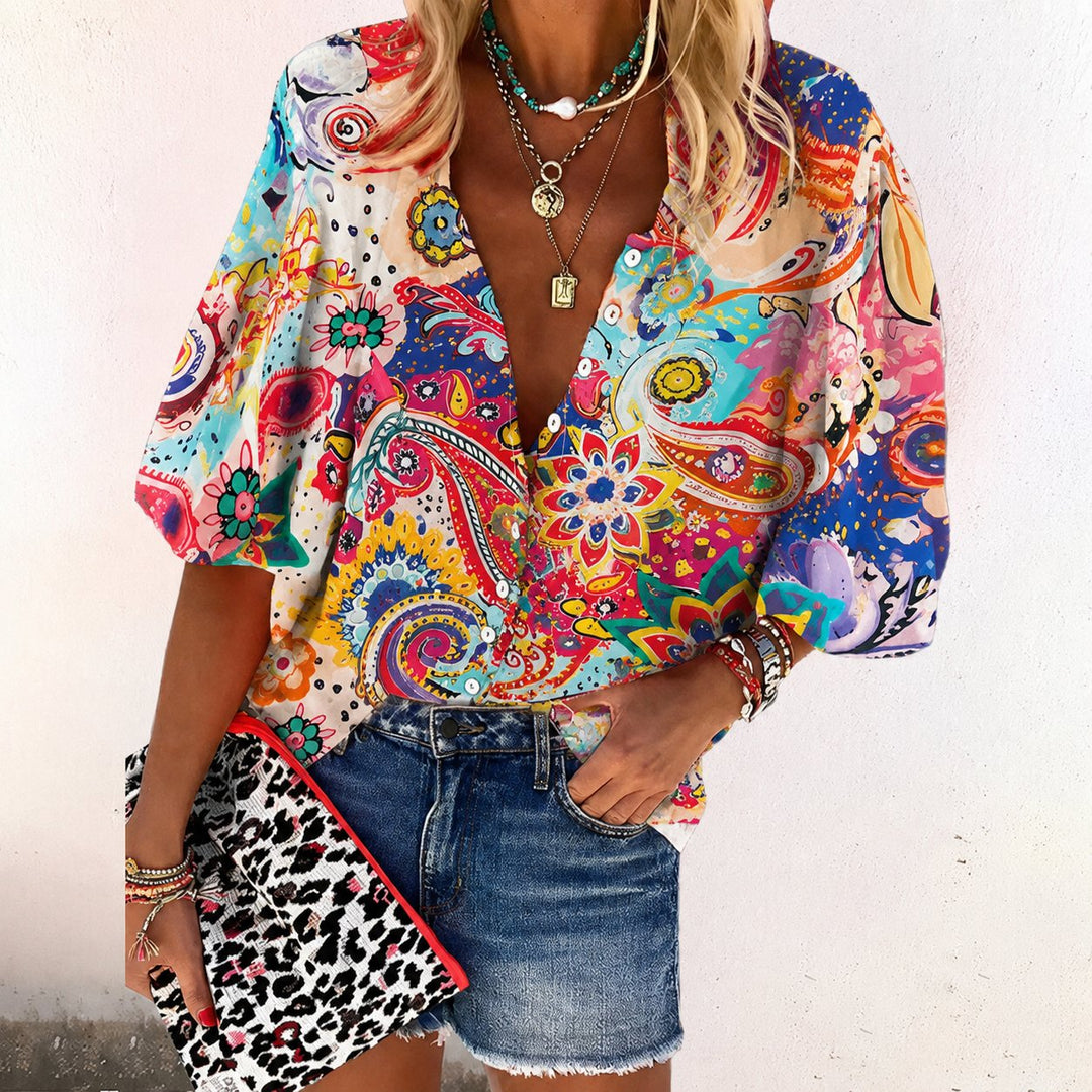 Vibrant floral print short sleeve blouse with a flattering V-neck, ideal for spring & summer casual outfits.