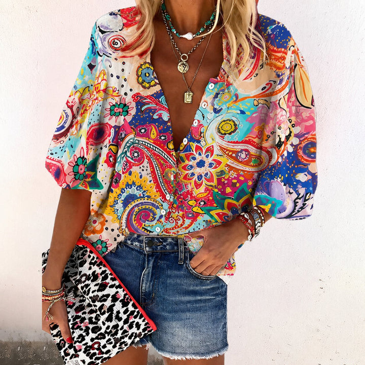 Vibrant floral print short sleeve blouse with a flattering V-neck, ideal for spring & summer casual outfits.