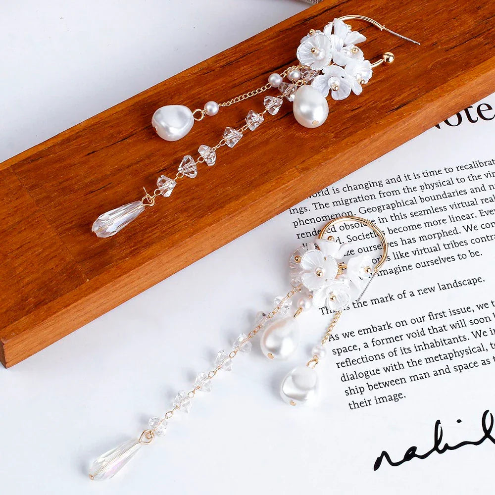 Close-up of women's Bohemian pearl & crystal dangle earrings, perfect fashion accessory.