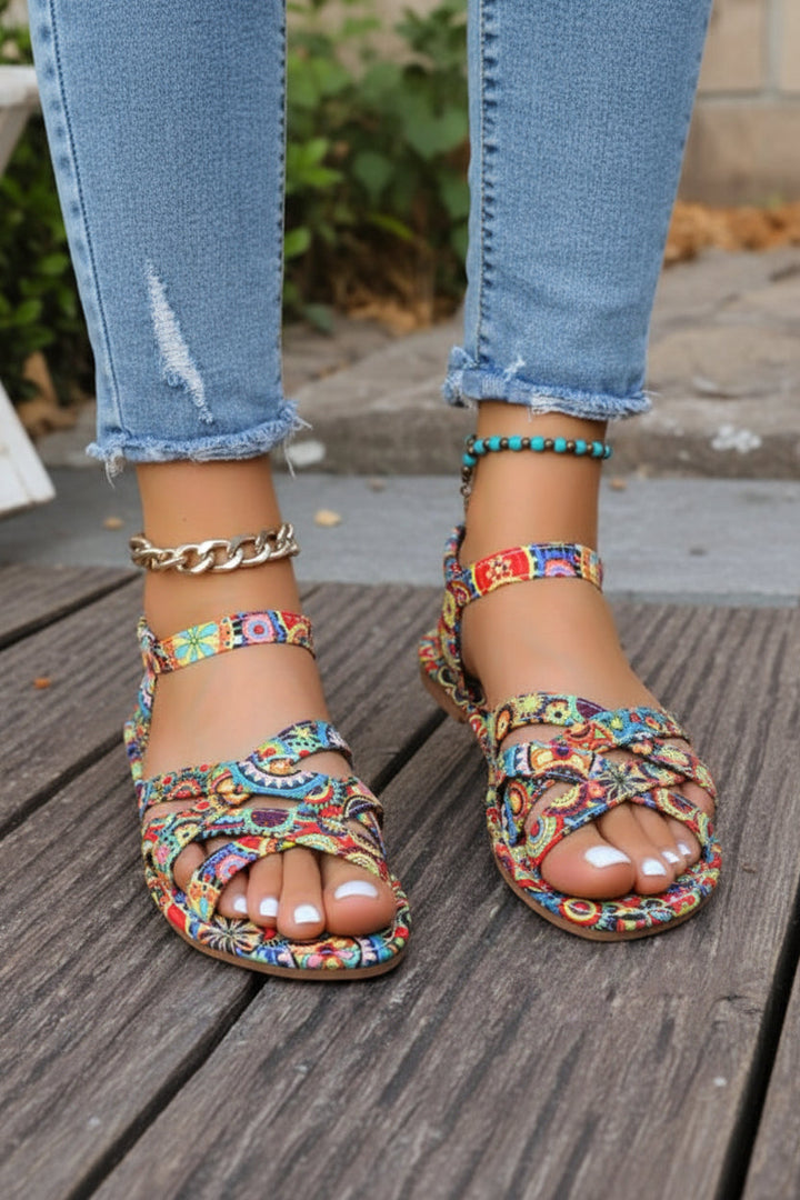 Chic women's bohemian print T-strap flat sandals, essential summer footwear for comfort and style on vacation.