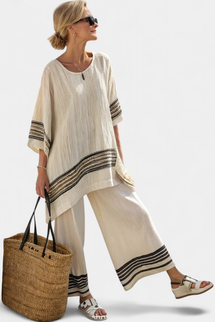Striped bohemian two-piece lounge set for women. Casual oversized top and wide-leg pants. Ideal for resort wear.