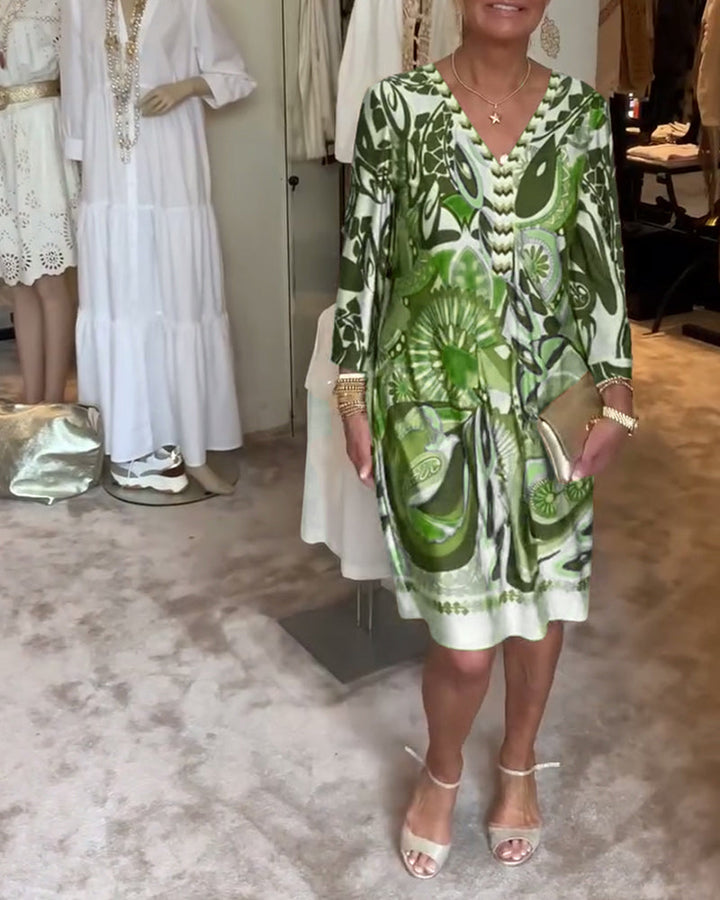 Abstract sunburst printed v-neck tunic dress, a vibrant Bohemian style for women's casual summer fashion.