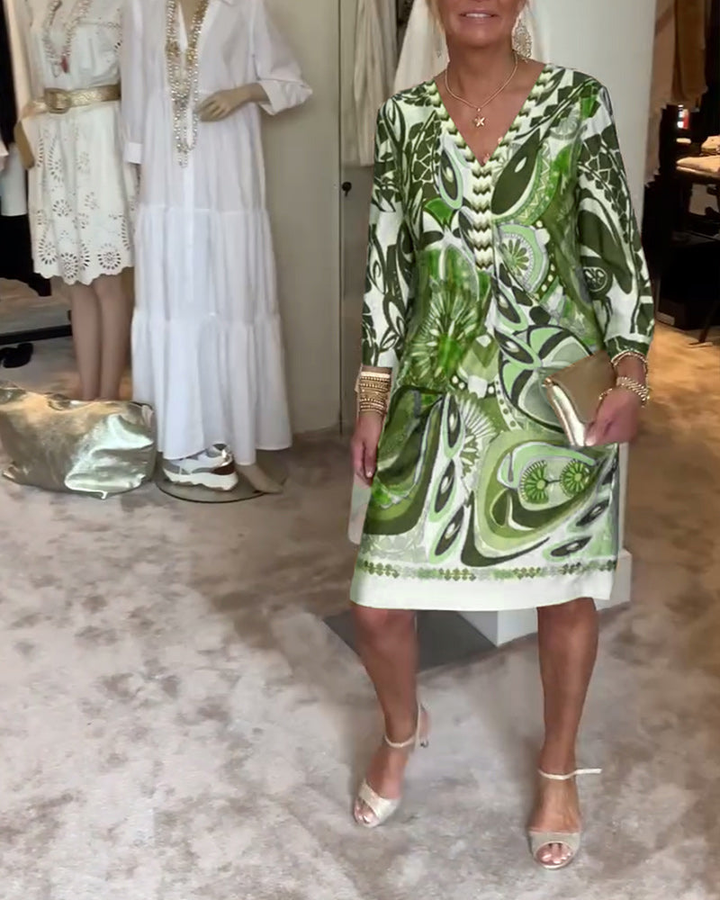 Women's colorful Bohemian sunburst printed tunic dress, a flowy retro-inspired V-neck for summer outings.