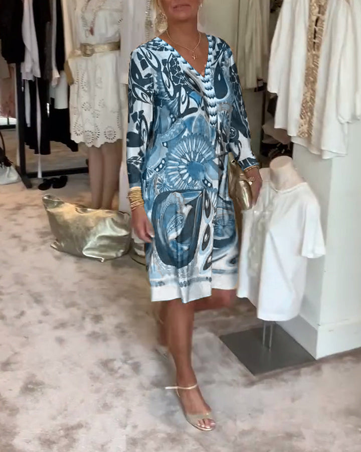 Retro abstract sunburst print on a women's Bohemian tunic dress, ideal for summer resort fashion.
