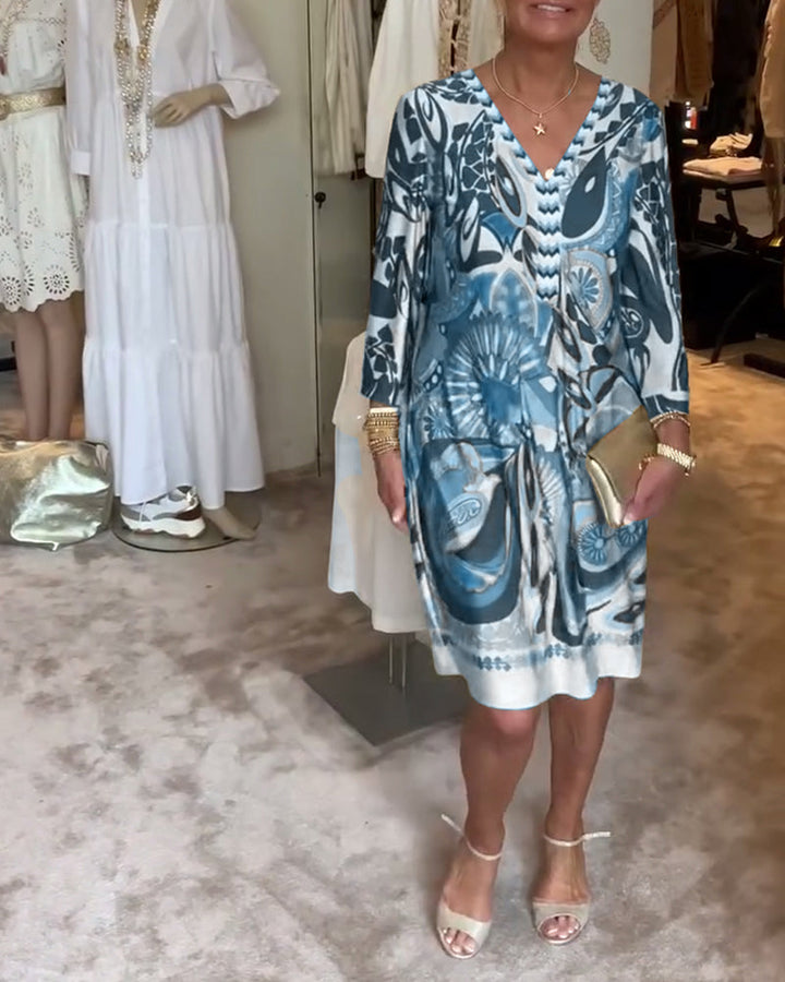 Comfortable women's flowy Bohemian tunic dress with vibrant sunburst print, great for casual summer days.