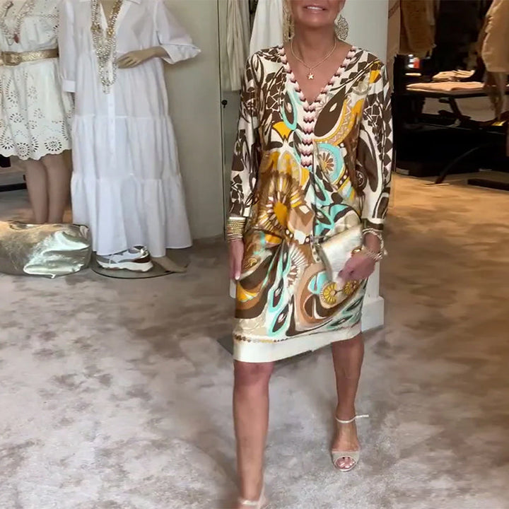 Chic women's Bohemian sunburst tunic dress, featuring a colorful abstract print & flowy fit for summer fashion.