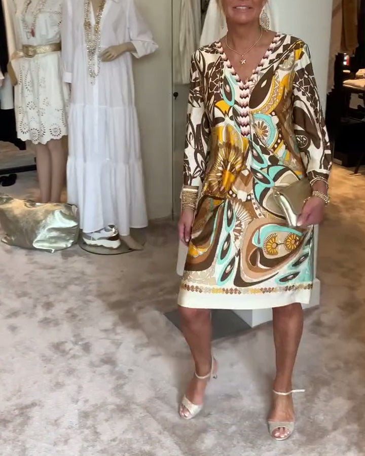 Vibrant women's retro sunburst printed tunic dress, perfect for casual summer days or resort vacation.