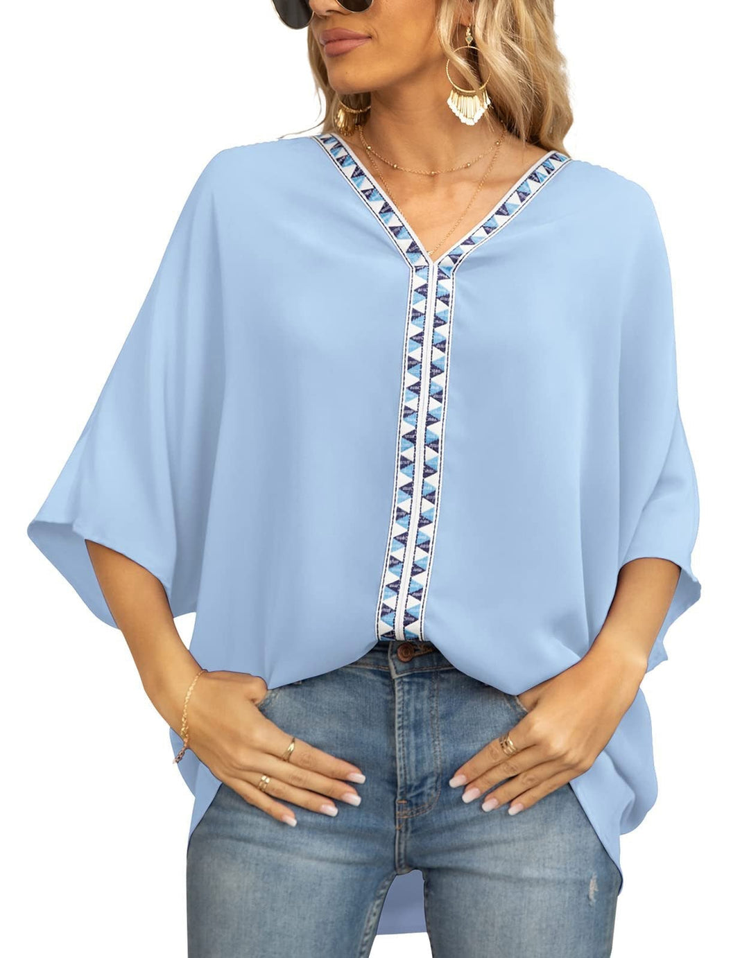 Embroidered women's bohemian blouse with a V-neck, half sleeves, and a unique geometric pattern.