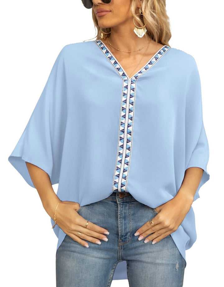 Embroidered women's bohemian blouse with a V-neck, half sleeves, and a unique geometric pattern.