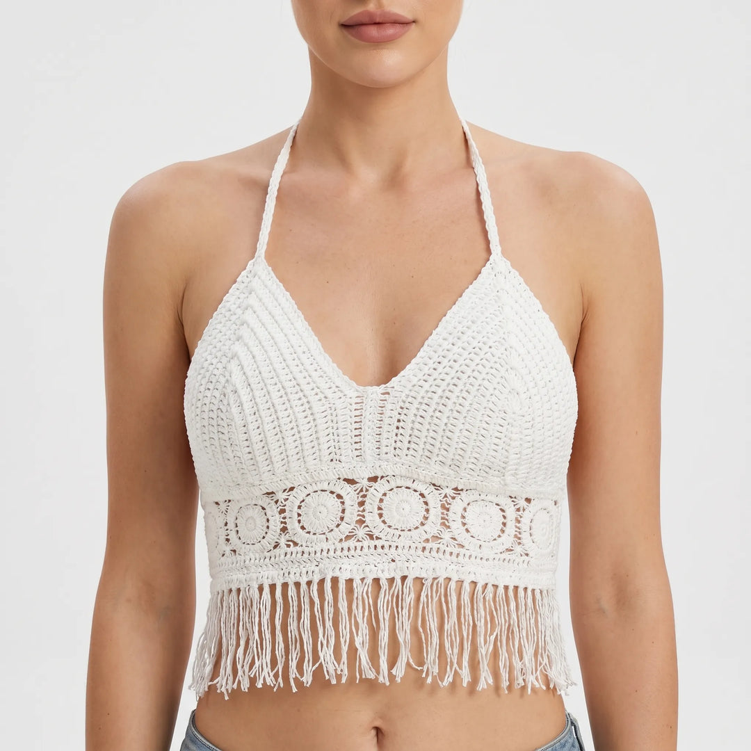 Chic women's fringed crochet halter crop top, sleeveless bohemian style for resort wear.