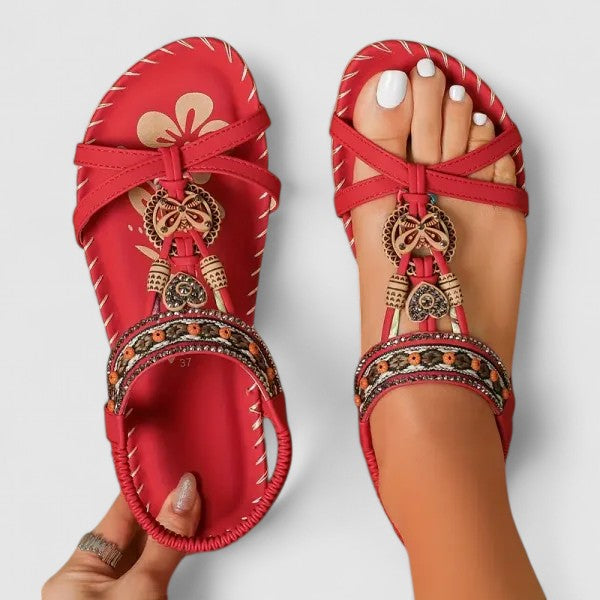 Women's boho ethnic embroidered flat sandals with tassel detail. Perfect summer casual footwear.