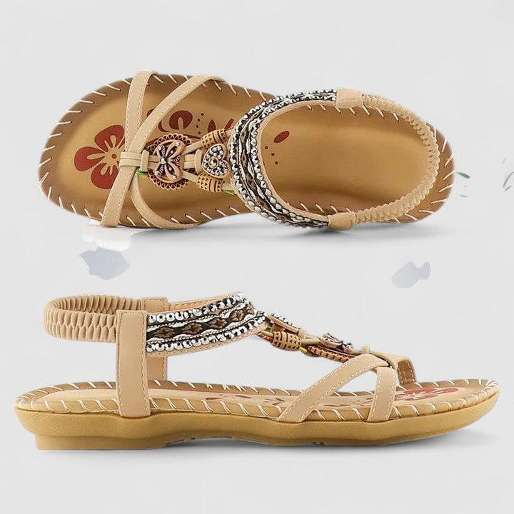 Boho chic women's flat sandals with vibrant ethnic embroidery and tassel accents. Summer ready.