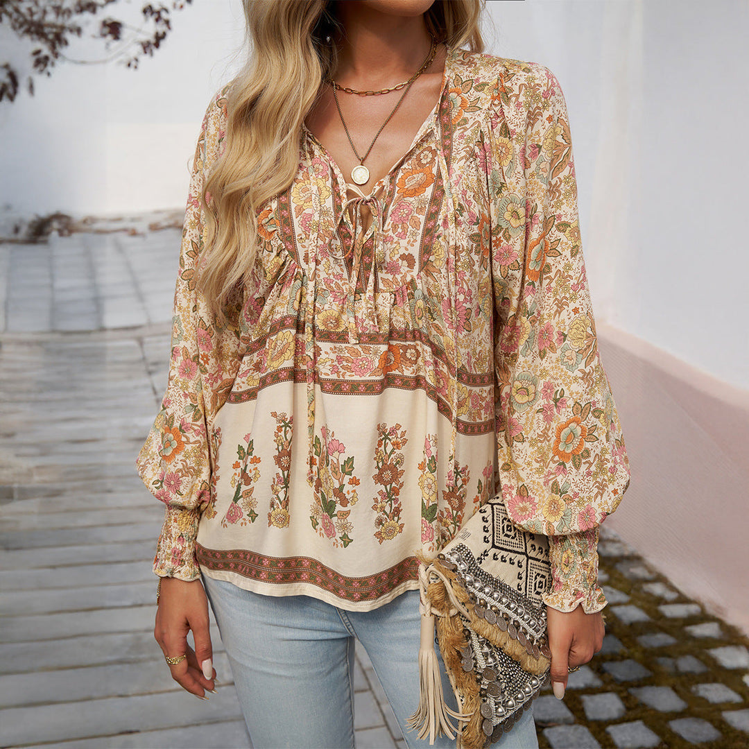 Women's floral print boho blouse, loose fit, puff sleeves, V-neck. Stylish everyday summer fashion top.