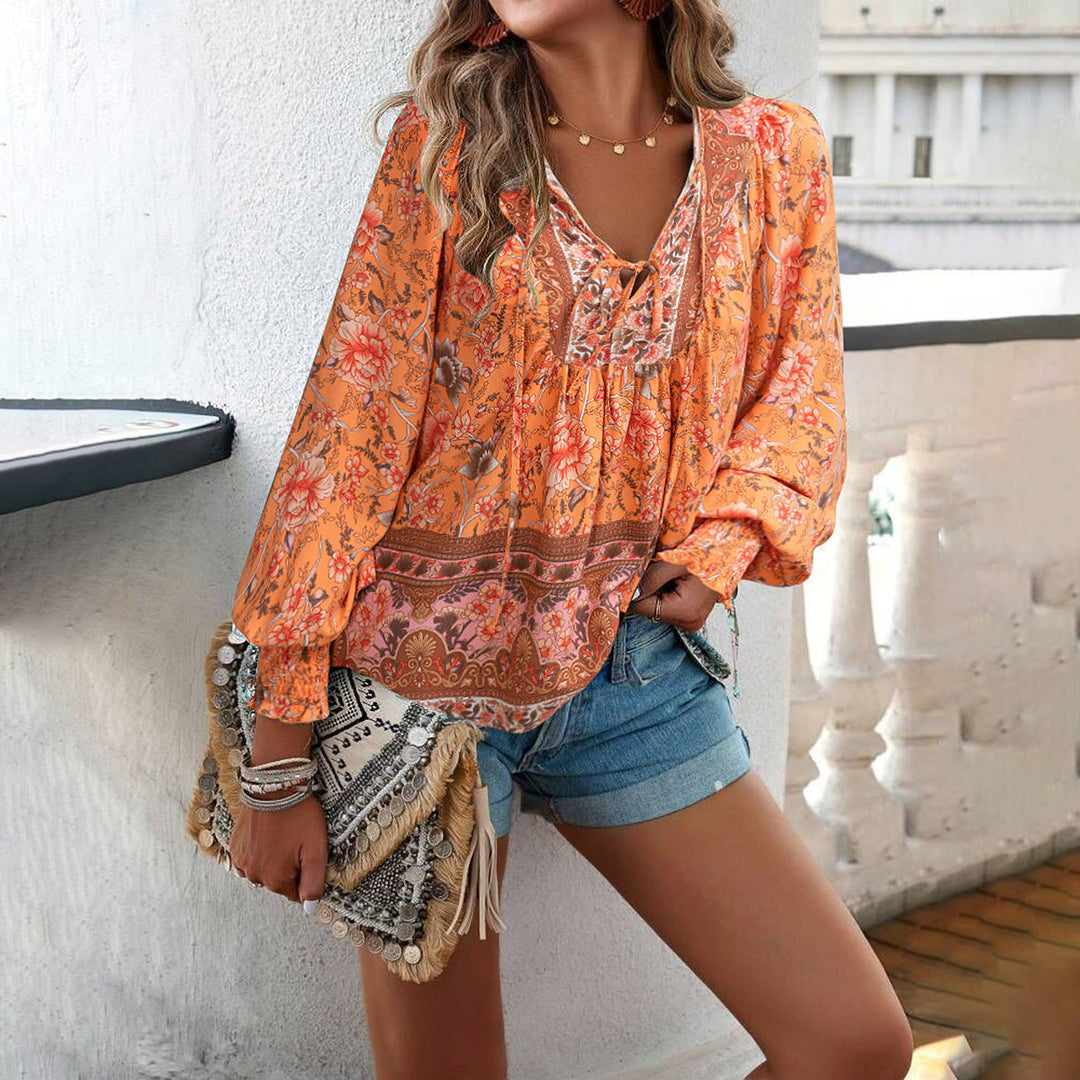 Elegant women's bohemian floral blouse with puff sleeves. Loose, stylish V-neck top for casual chic look.