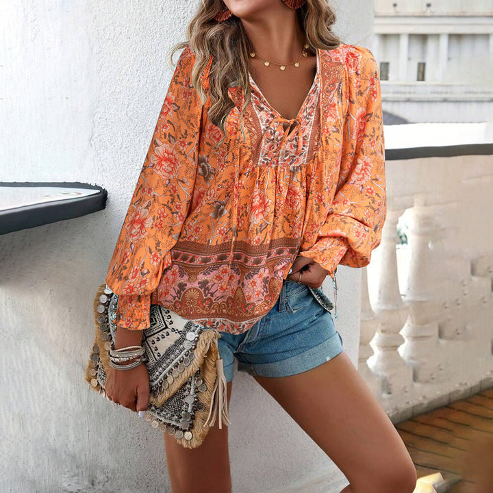Elegant women's bohemian floral blouse with puff sleeves. Loose, stylish V-neck top for casual chic look.