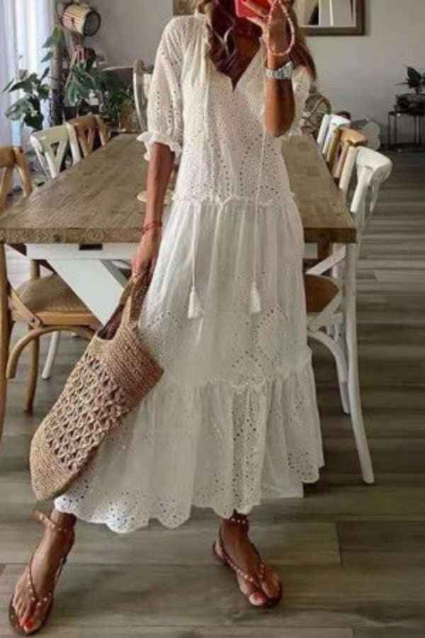 Flowing women's boho floral maxi dress featuring a chic tassel V-neck. Ideal for festivals & casual elegance.