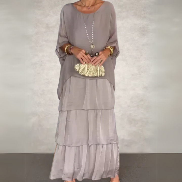 Casual elegant women's boho maxi dress set with a relaxed batwing top and layered skirt.