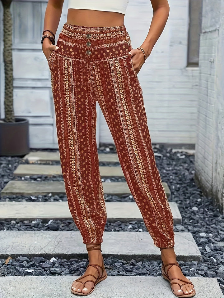 Women's boho high-waist trousers with a vibrant print & comfortable smocked waist, perfect for summer.