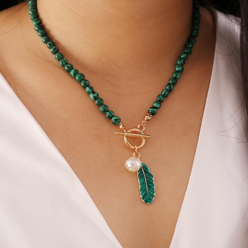 Women's boho malachite & pearl aura necklace. Spiritual healing gemstone jewelry with elegant design.