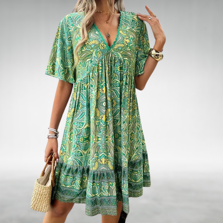 Bohemian style women's mini dress featuring vibrant paisley print & short sleeves, ideal for vacation or day wear.