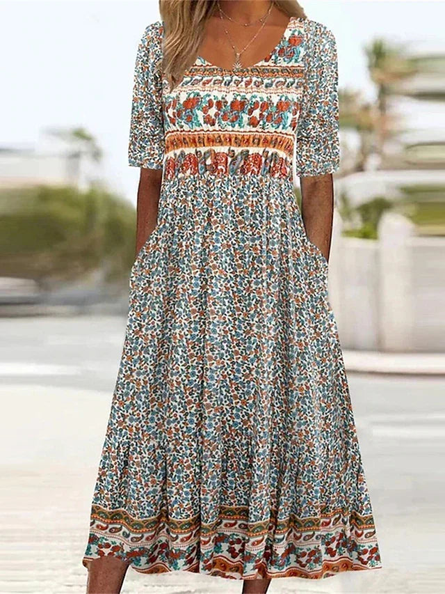 Women's boho print midi dress with gathered waist, short sleeves, and practical side pockets, perfect for summer.