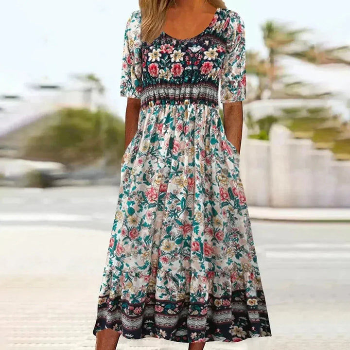 Close-up of a women's boho midi dress showing detailed print, gathered waist, round neck, and soft fabric.