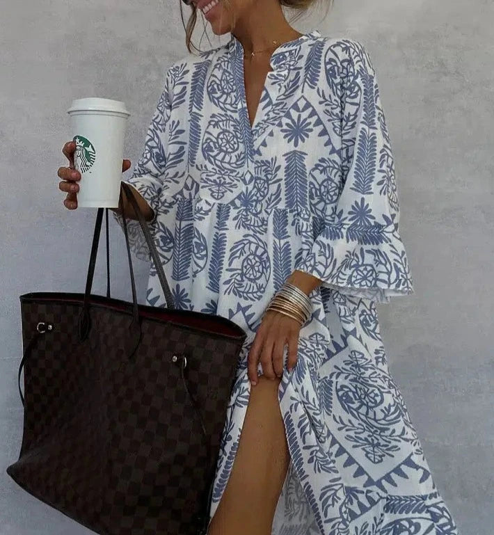 Casual bohemian style women's swing dress featuring a vibrant print, V-neck, and comfortable 3/4 sleeves.