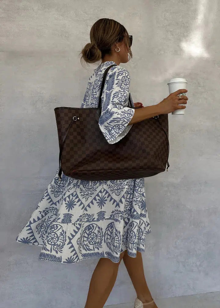 Stylish printed women's V-neck swing dress with 3/4 sleeves. A versatile bohemian summer midi dress.