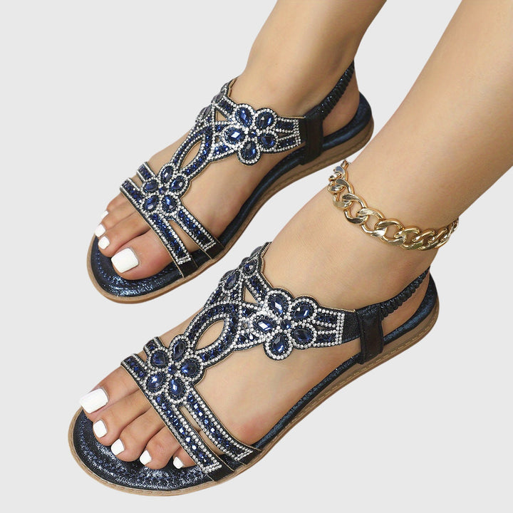 Vacation essentials: Women's glamorous rhinestone flat sandals.