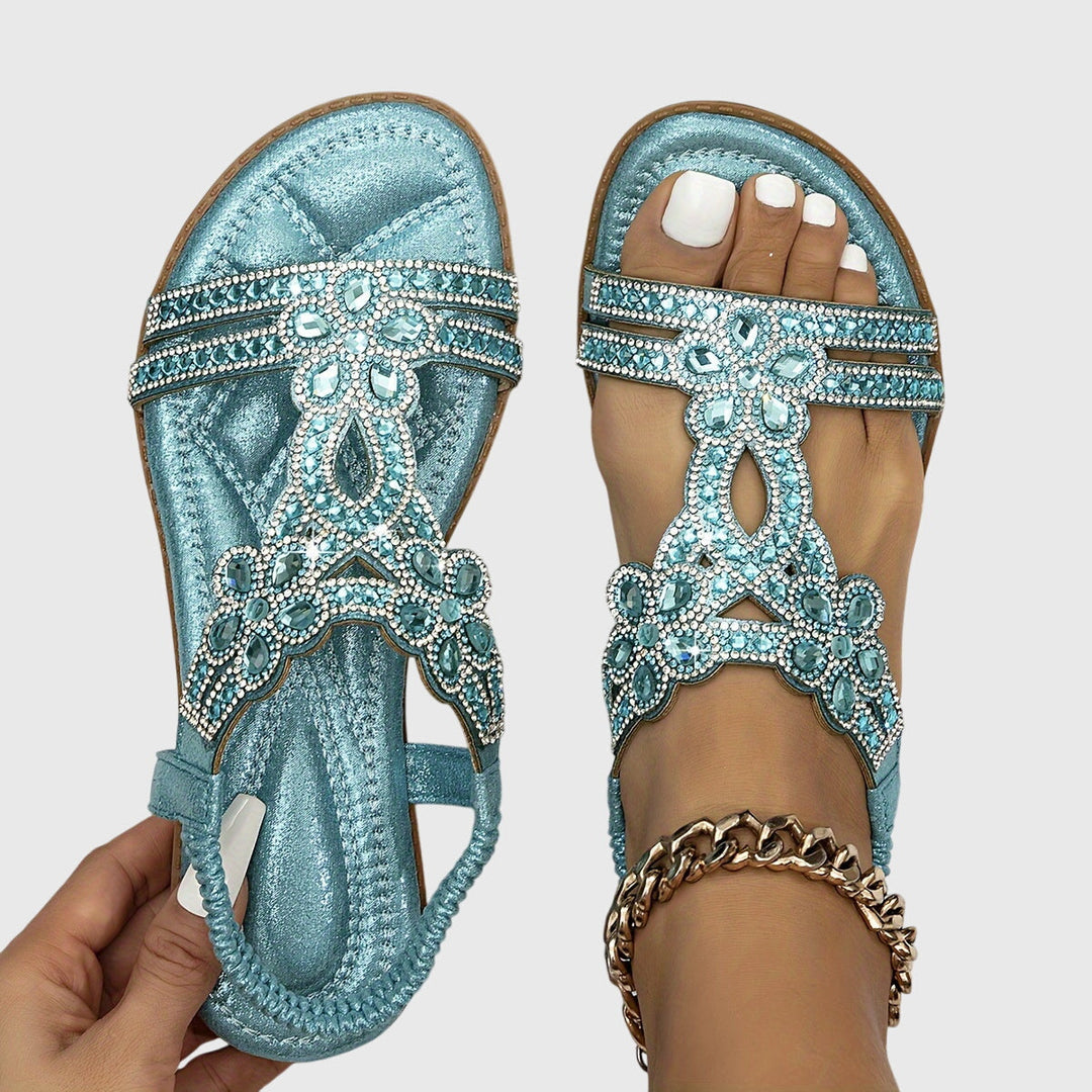 Elegant women's flat sandals with sparkling rhinestone embellishments.