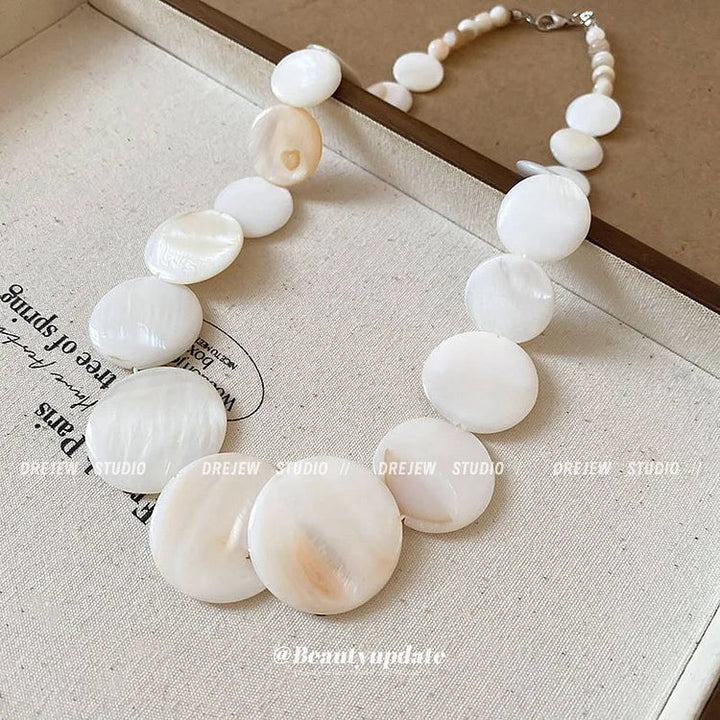 Natural shell choker necklace in boho style for women. Adjustable, perfect summer beach jewelry accessory.