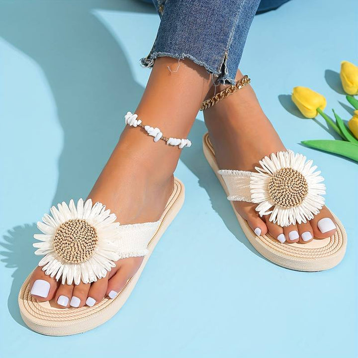 Chic women's slip-on flat sandals. Boho style with a cute daisy flower accent, ideal for summer beach & casual outfits.